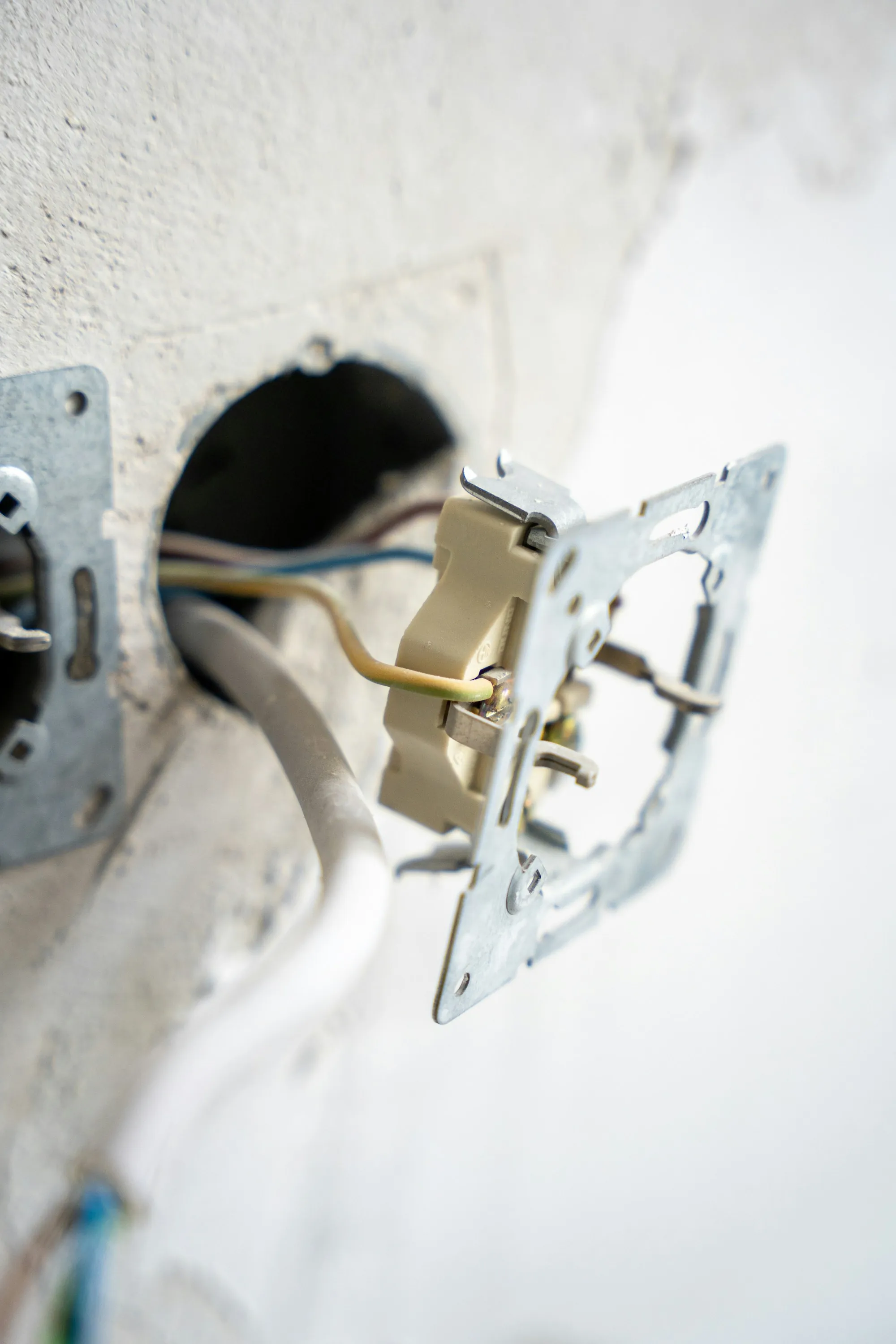 Open outlet box with wiring ready for a new device