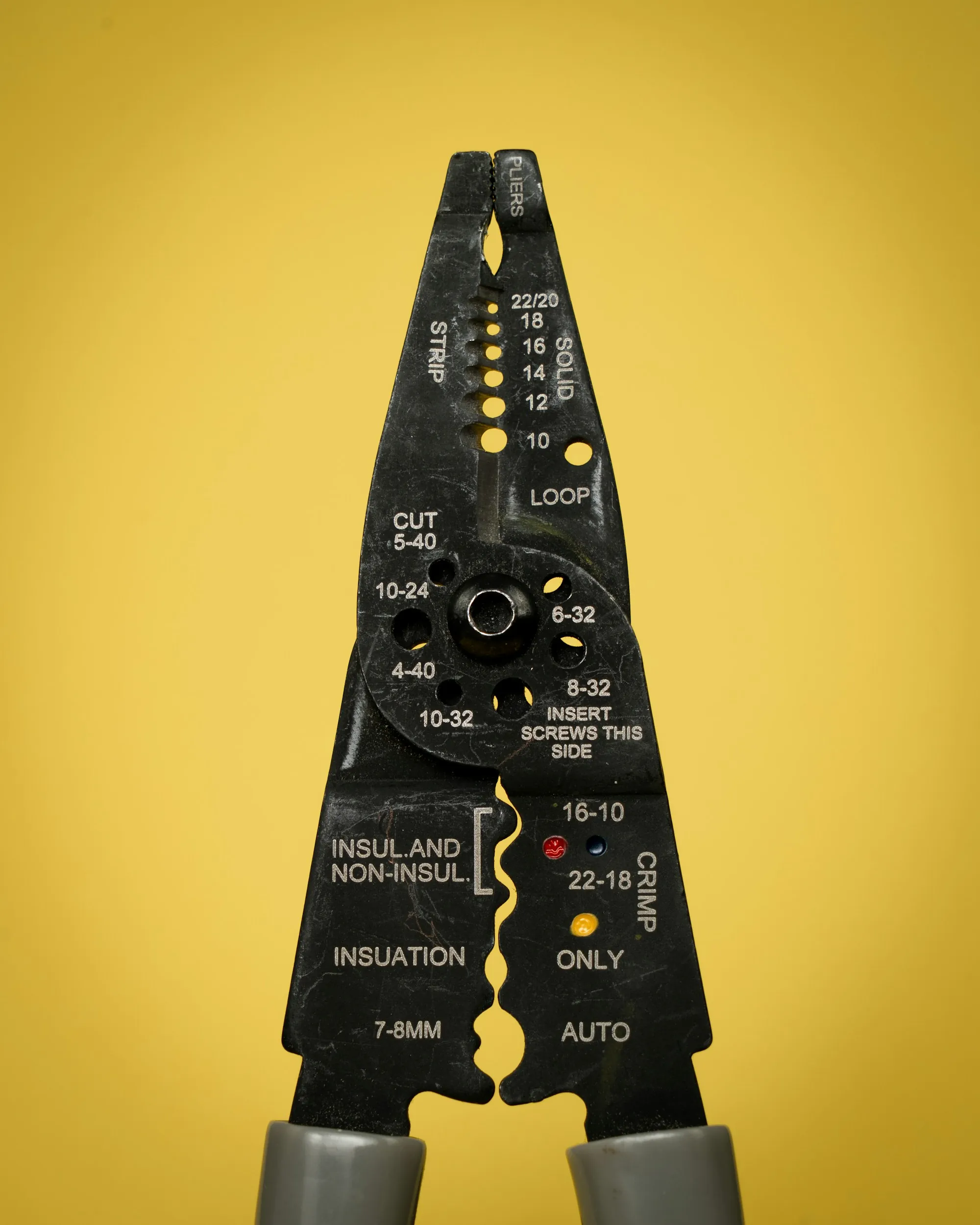 Wire stripping tool on a yellow background