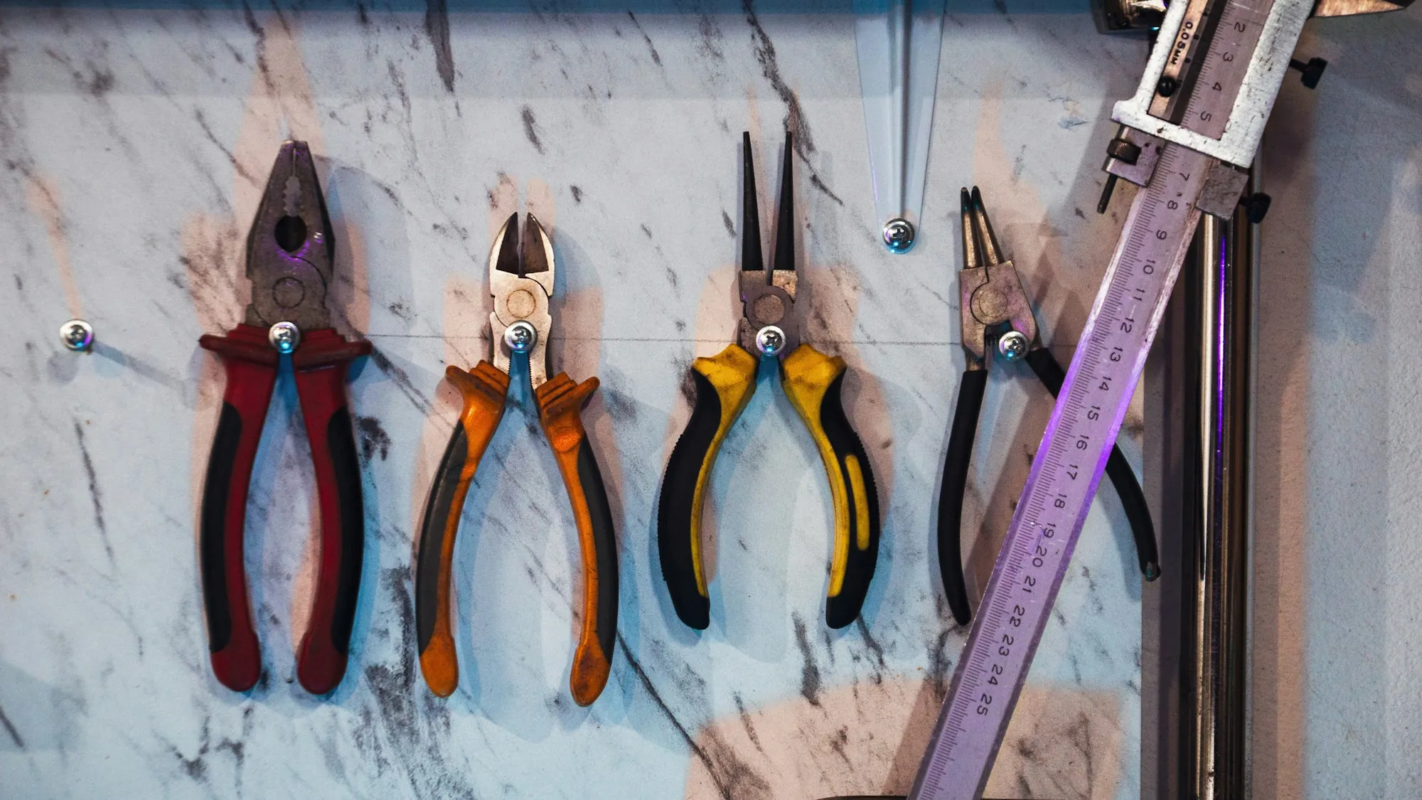 Pliers and hand tools hanging on a wall