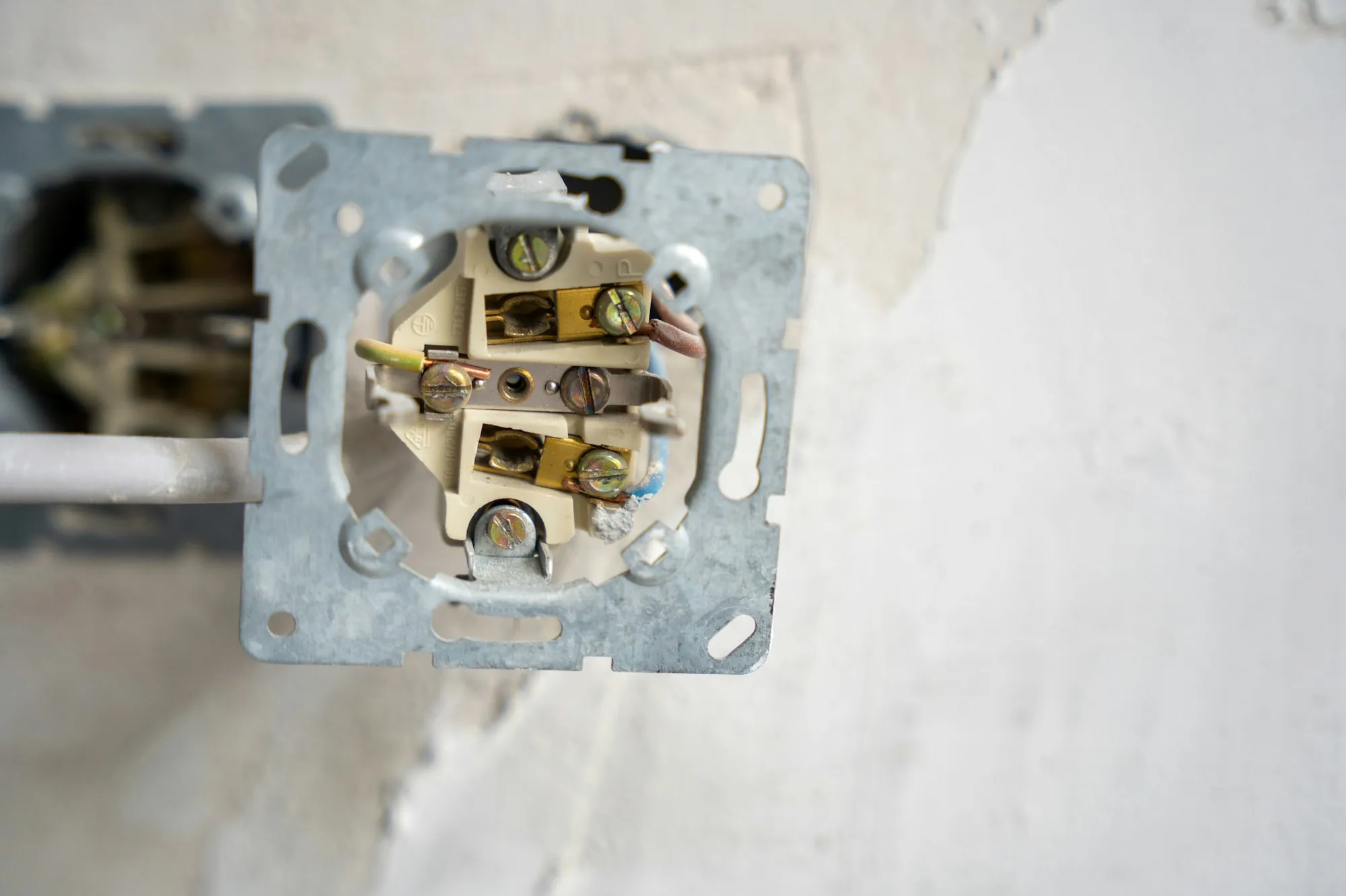 Opened outlet box showing wiring connections