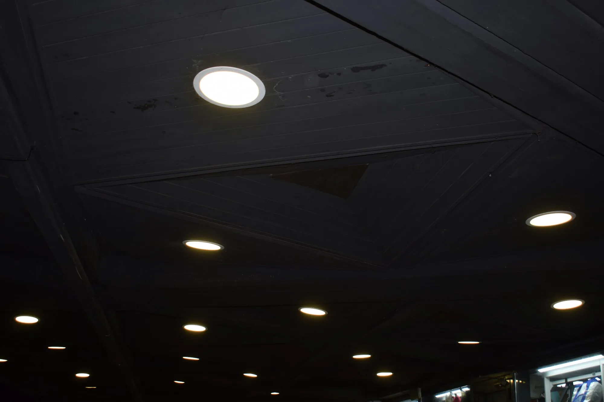 Recessed lights glowing in a dark ceiling